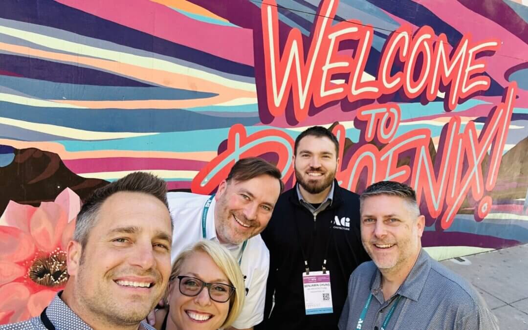 AG Architecture team members enjoy a selfie moment at the Welcome to Phoenix sign during the 2026 EFA conference and expo.
