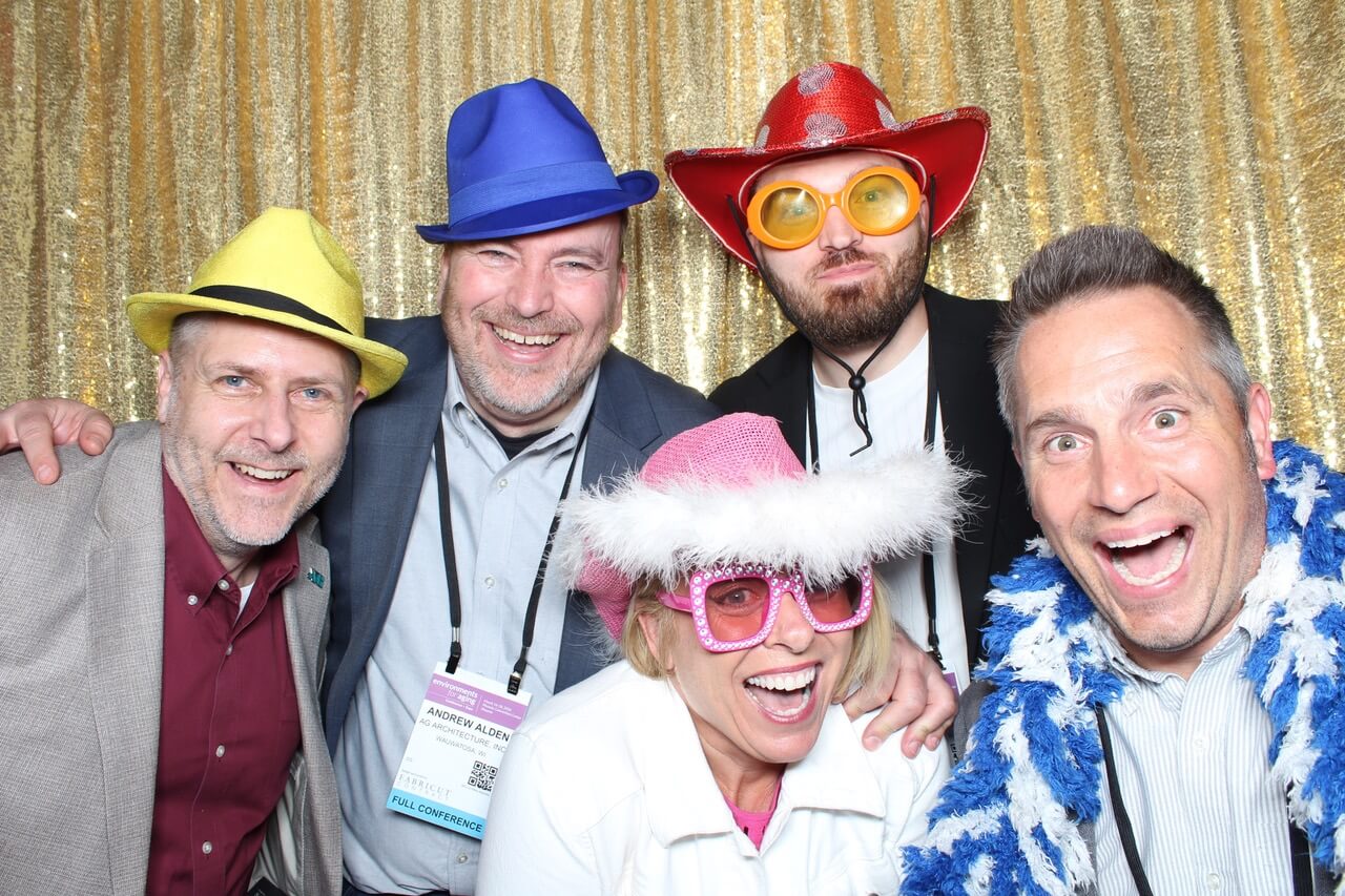 The AG Team celebrates at the SAGE event with photo booth fun.
