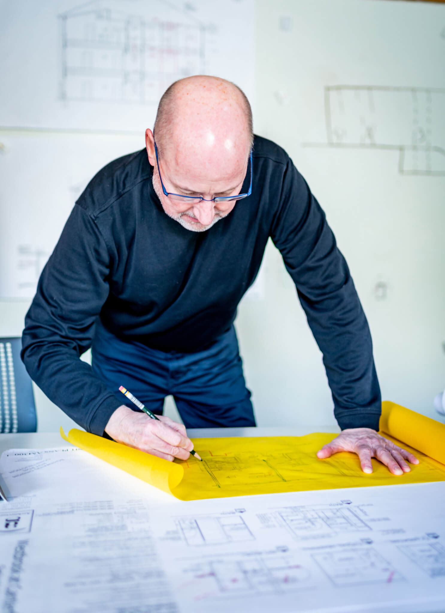 John Cronin uses yellow trace paper to sketch at AG Architecture's critique space.